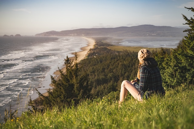Picture of person staring at the ocean, photo by Myles Tan, via Unsplash